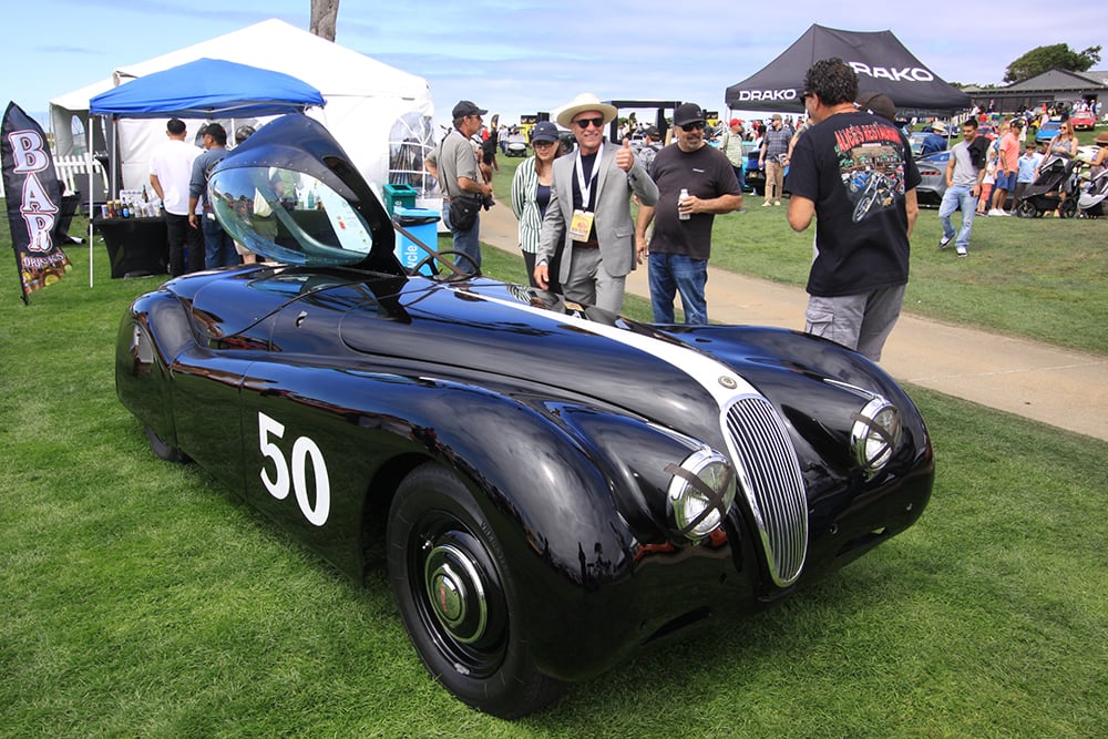 Jaguar XK120 black owner thumbs up